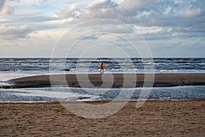 Surfer finished his training on cold water of North sea near Zandvoort in Netherlands