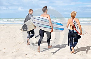 Surfer friends, running and back at beach with board, training or fitness on vacation in summer. Men, woman and