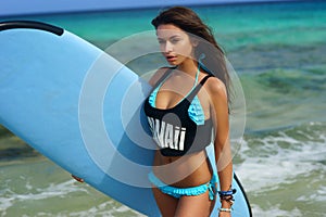 Surfer girl with board at beach