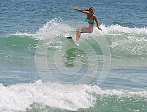 Surfer Girl Carving a Wave in the Outer Banks of NC