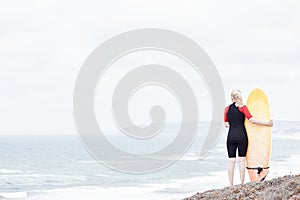 Surfer girl near ocean