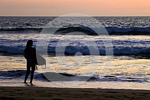 A Surfer Girl at Sunset.