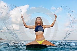 Surfer girl on surfboard have a fun before surfing