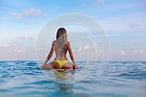 Surfer girl on surfboard have a fun before surfing