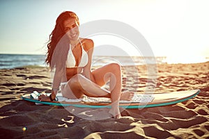 Surfer girl in swimsuit bikini. Summer, holidays on the beach