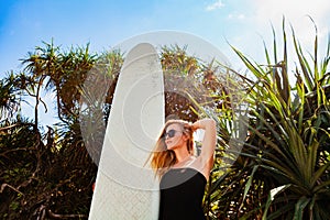 Surfer girl on tropical beach