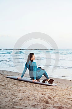 Surfer girl walking with board on the sandy beach. Surfer female.Beautiful young woman at the beach. water sports. Healthy Active