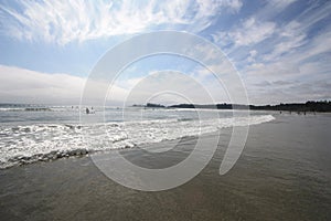 A surfer going out to catch a wave at beach.