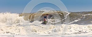 Surfer on huge waves