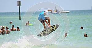 Surfer jumping on sailboard