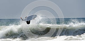 A Surfer jumps a big Wave At Newport Beach In California