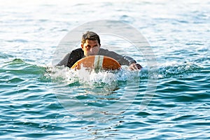 Surfer on longboard over the water