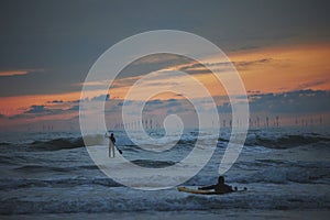 Surfer in the North Sea in the Netherlands at night