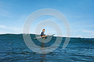 Surfer In Ocean. Surfing Man On Surfboard Catching Wave. Water Sport For Active Lifestyle.