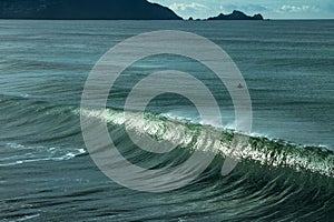 Surfer in the ocean waiting for the perfect wave.