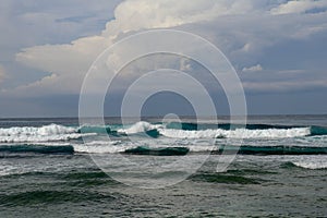 Surfer in the ocean waiting for a wave. Surfers waiting for good surfing waves. Surfers waiting for their wave. Young man waiting