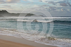 Surfer at Pacifico beach, Siargao, Philippines photo