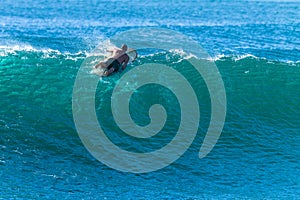 Surfer Paddles Over Cresting Wave Escape Beating