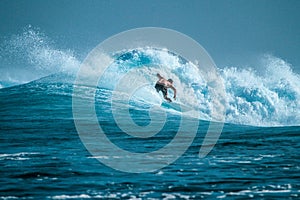 Surfer on perfect blue aquamarine wave, empty line up, perfect for surfing, clean water, Indian Ocean