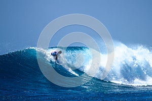 Surfer on perfect blue aquamarine wave, empty line up, perfect for surfing, clean water, Indian Ocean