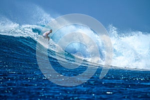 Surfer on perfect blue aquamarine wave, empty line up, perfect for surfing, clean water, Indian Ocean