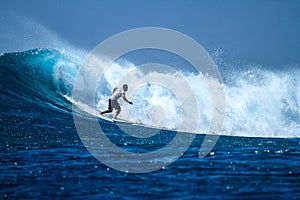 Surfer on perfect blue aquamarine wave, empty line up, perfect for surfing, clean water, Indian Ocean