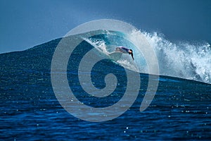 Surfer on perfect blue aquamarine wave, empty line up, perfect for surfing, clean water, Indian Ocean