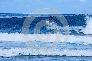 Surfer on perfect blue aquamarine wave, empty line up, perfect for surfing, clean water, Indian Ocean