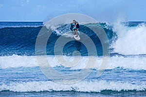 Surfer on perfect blue aquamarine wave, empty line up, perfect for surfing, clean water, Indian Ocean