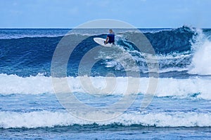 Surfer on perfect blue aquamarine wave, empty line up, perfect for surfing, clean water, Indian Ocean