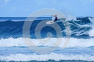 Surfer on perfect blue aquamarine wave, empty line up, perfect for surfing, clean water, Indian Ocean