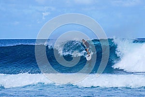 Surfer on perfect blue aquamarine wave, empty line up, perfect for surfing, clean water, Indian Ocean