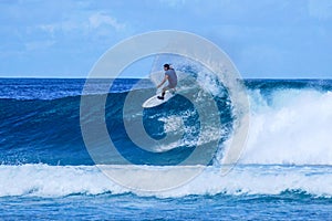 Surfer on perfect blue aquamarine wave, empty line up, perfect for surfing, clean water, Indian Ocean