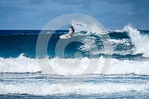 Surfer on perfect blue aquamarine wave, empty line up, perfect for surfing, clean water, Indian Ocean