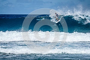 Surfer on perfect blue aquamarine wave, empty line up, perfect for surfing, clean water, Indian Ocean