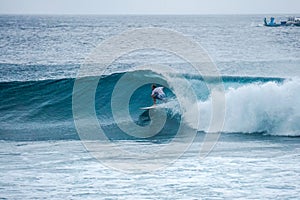 Surfer on perfect blue aquamarine wave, empty line up, perfect for surfing, clean water, Indian Ocean