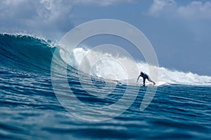 Surfer on perfect blue aquamarine wave, empty line up, perfect for surfing, clean water, Indian Ocean