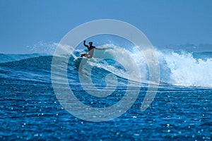 Surfer on perfect blue aquamarine wave, empty line up, perfect for surfing, clean water, Indian Ocean