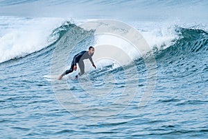 Surfer performing a bottom turn