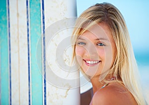 Surfer, portrait and woman with a smile at beach in summer, vacation or holiday with sports, board or fun. Happy, face