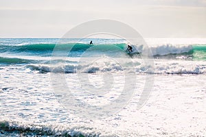 Surfer ride on ideal blue wave. Winter surfing in ocean