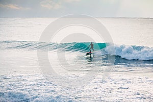 Surfer ride on wave. Winter surfing in ocean