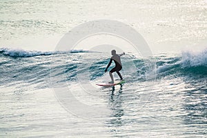 Surfer ride on wave. Winter surfing in ocean