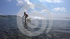 Surfer rides crystal clear ocean wave