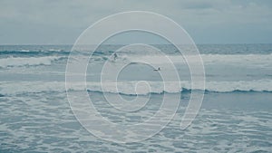 Surfer rides Ocean Waves at beach at Bali in Slow Motion