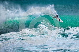 Surfer riding big wave