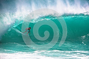 Surfer riding big wave in Bali