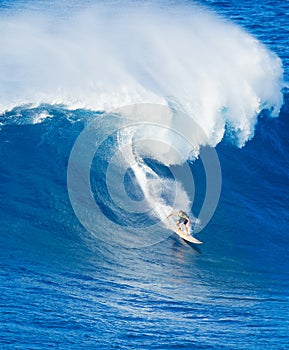 Surfer riding giant wave