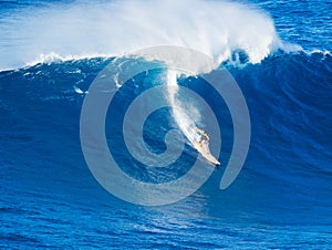 Surfer riding giant wave