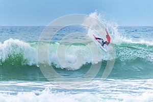 Surfer riding a huge wave during World surf league competition in Lacanau France
